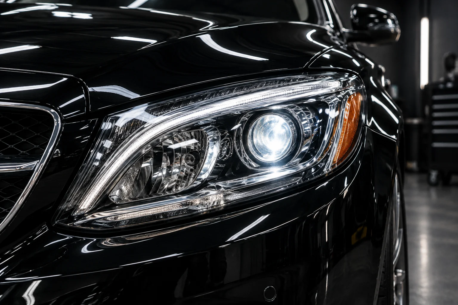 Clear restored headlight on a black sedan